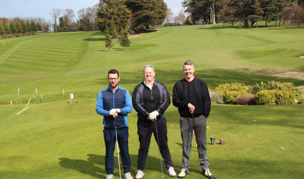 three golfers on golf course